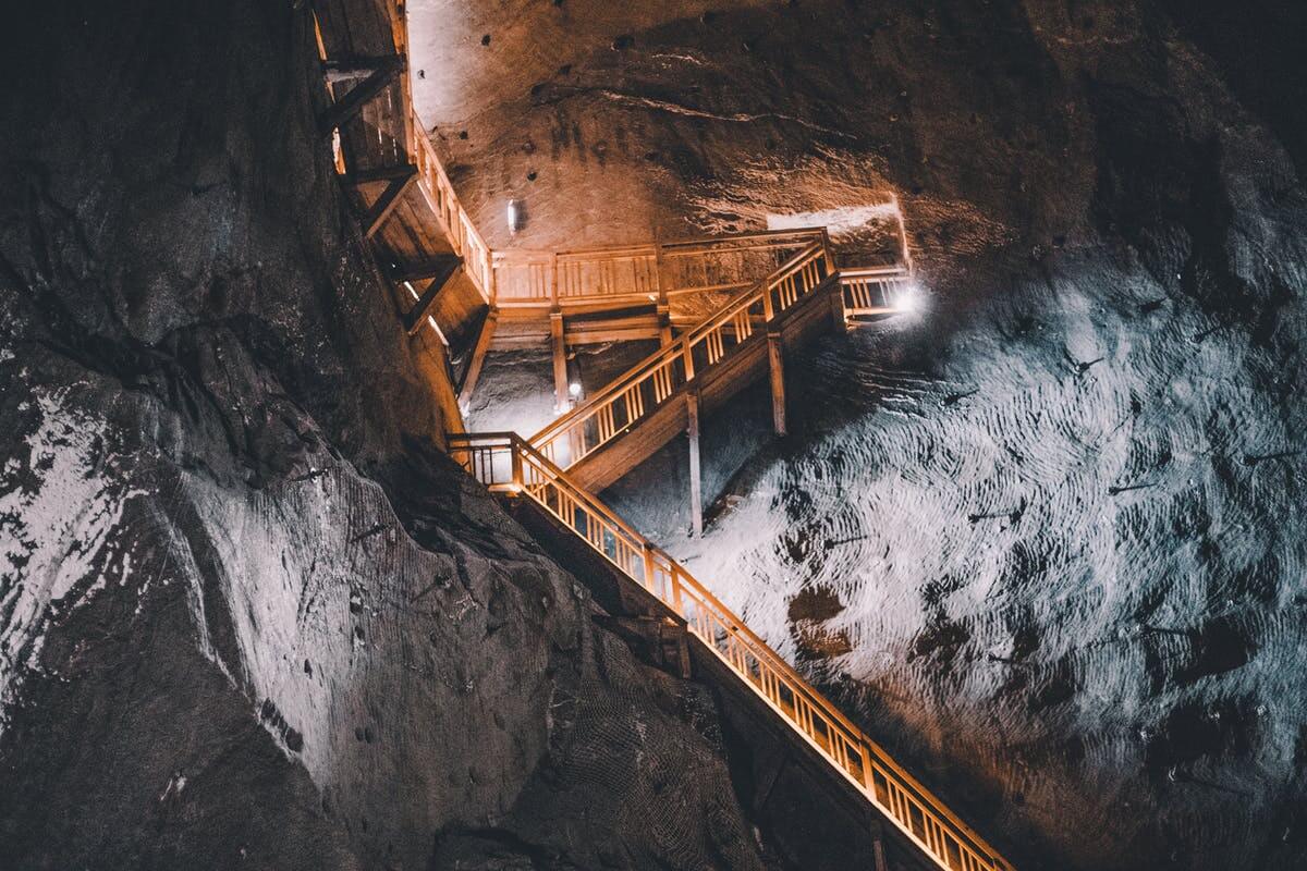 a wooden walkway leading up to a cave